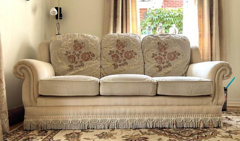 Cream Fabric Three-Seater Sofa with Floral Cushions in Good Condition