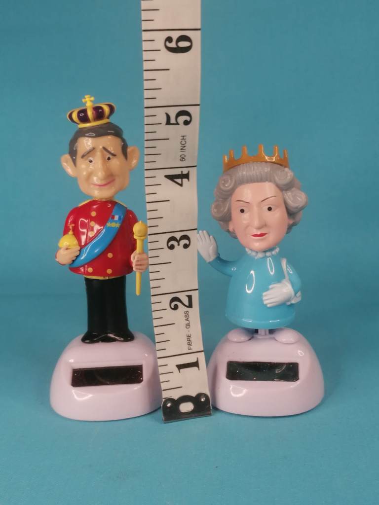 Solar powered novelty dancing pals - King Charles lll,  and Queen. Good condition.