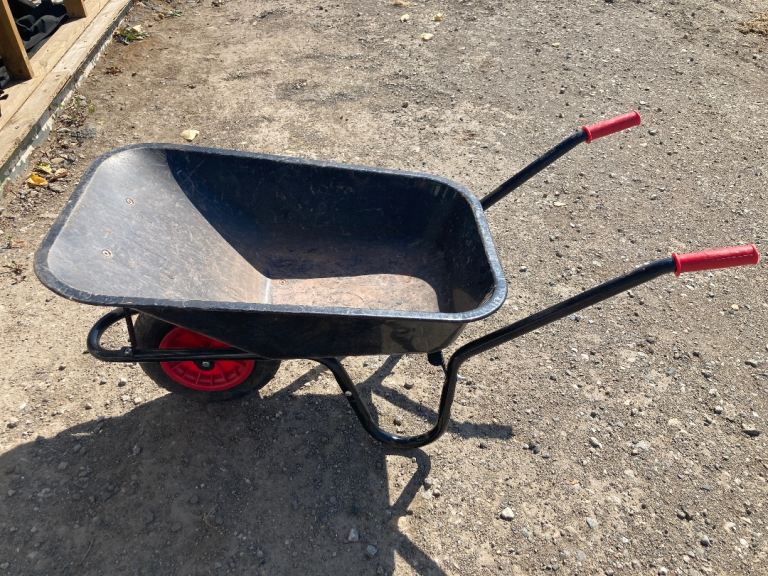 Used Black Wheelbarrow with Red Handles