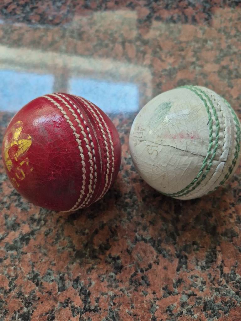 Pair of Cricket Balls – Red and White, Fair Condition