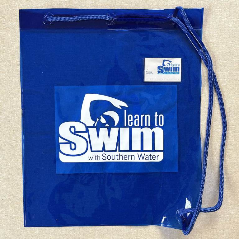 UNUSED blue vinyl/plastic swim bag. Name tag. Pull cord closure/carry strap. CAN POST