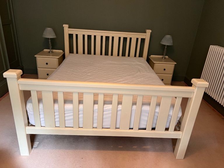 Two cream wooden bedside tables