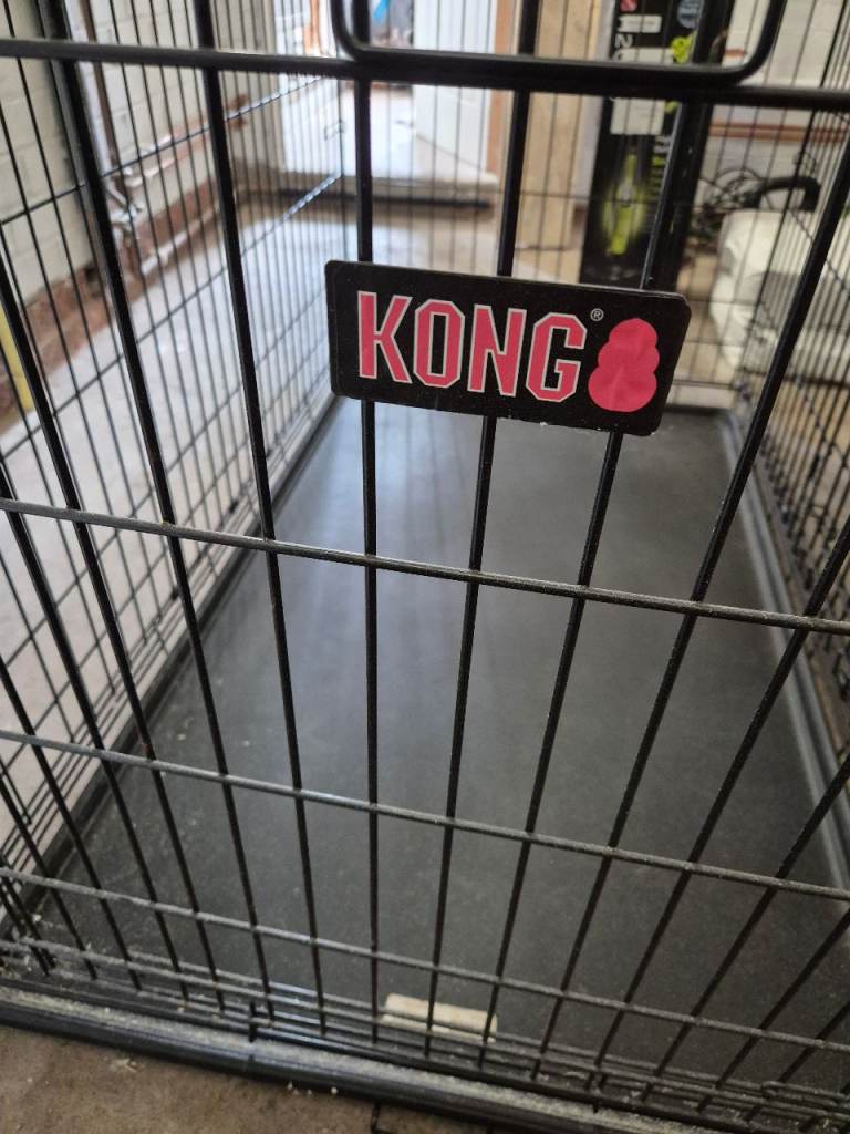 Large black metal dog crate with plastic tray, suitable for medium to large dogs