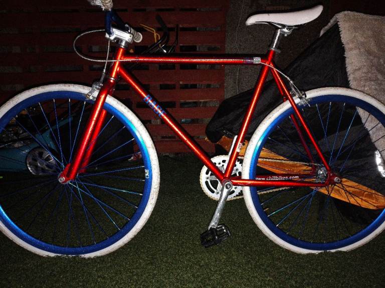 Red Single Speed Bike with Bold Blue Wheel Rims