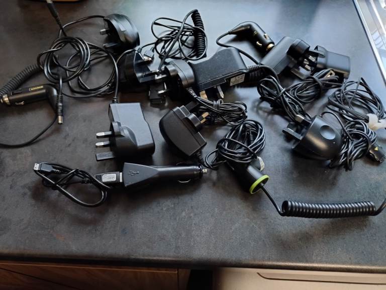 Bundle of Various Mobile Phone Chargers and Earphones