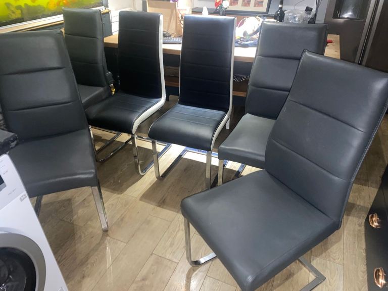 A SET OF SIX FAUX LEATHER CANTILEVER DINING CHAIRS OVERALL CONDITION IS GOOD ,FREE LOCAL DELIVERY