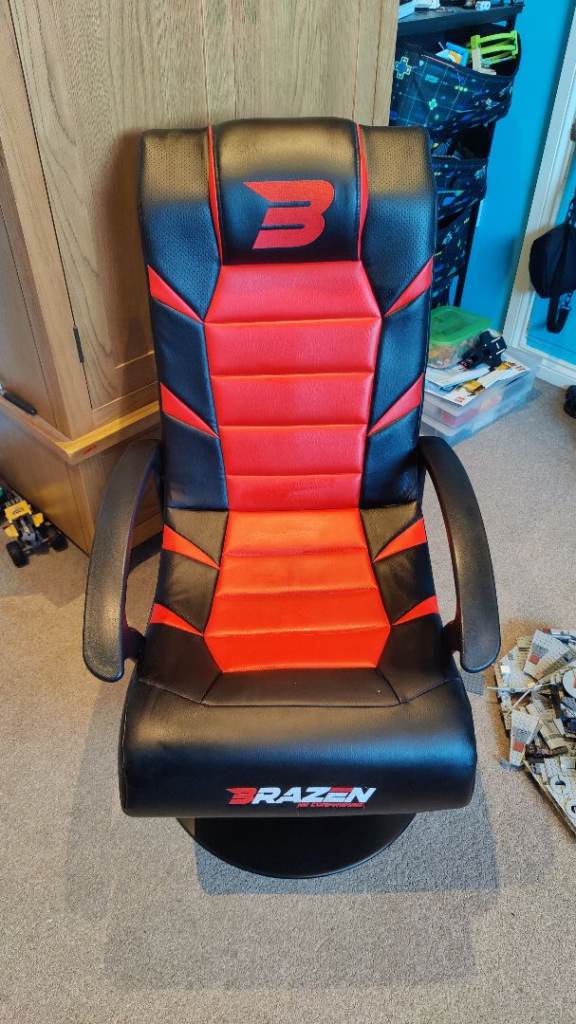 Gaming Chair by 'BraZen', foldable, with speakers and control panel in red and black.