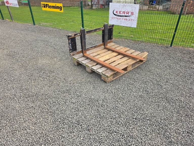 Loader tractor pallet forks and back plate has land legend siromer brackets 