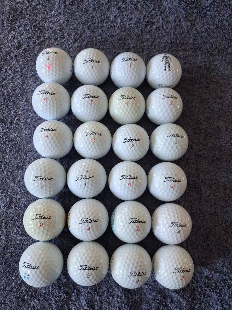 24 Used Pearly White Titleist Golf Balls. 