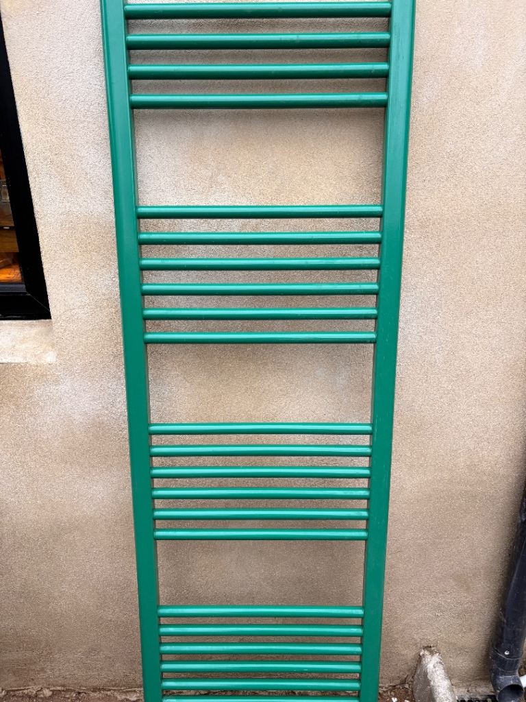 Bright green heated bathroom towel rail radiator 