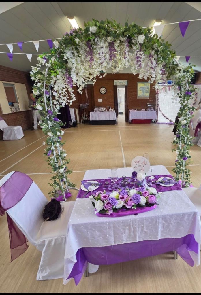 Freestanding celebration arch with flowers and lights