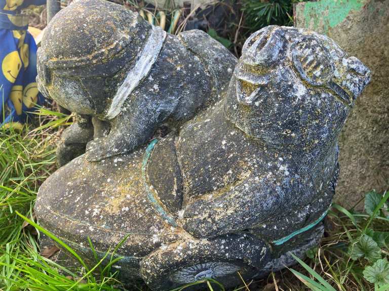 A couple of stone pigs , garden ornaments 