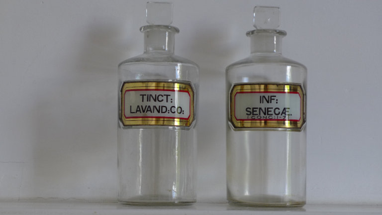 TWO DECORATIVE CLEAR GLASS APOTHECARY BOTTLES. PHARMACY JARS