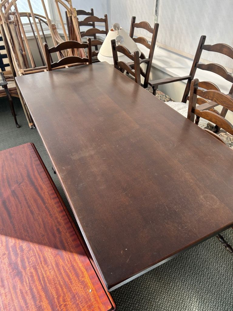 Large wooden dining table with 6 chairs.