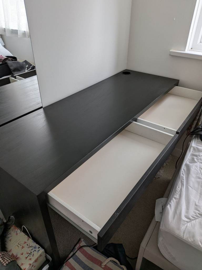 IKEA MICKE desk in black-brown, measuring 142x50 cm. 