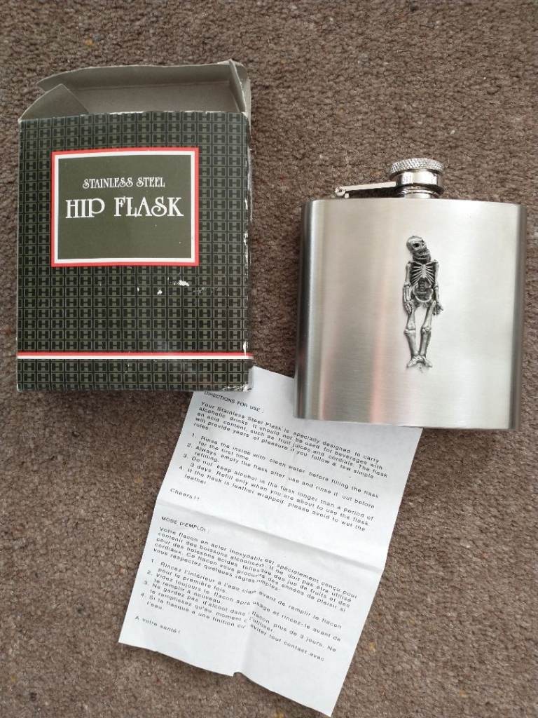HIP-FLASK. BRUSHED STAINLESS STEEL. Skeleton figure on front. New in box.