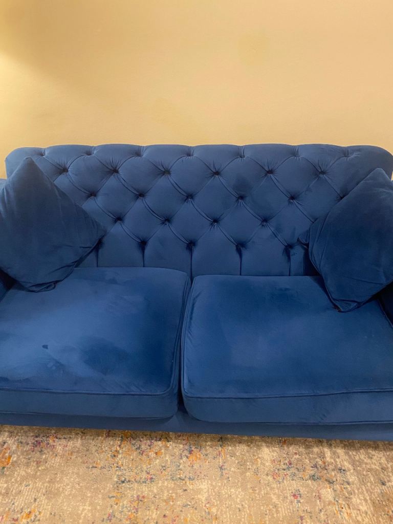Blue high backed Chesterfield sofa