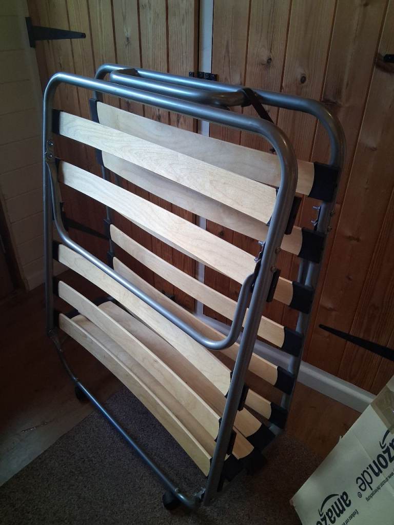 Z-bed with mattress.  Folds up and on castors for easy mobility.