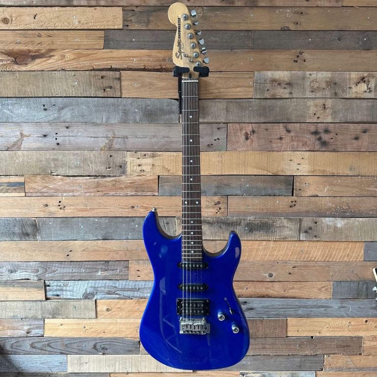This is a Squier Showmaster electric guitar in a blue finish. 