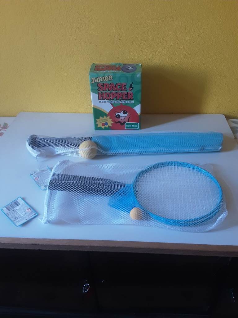 New toys . Badminton set , cricket bat and  ball . And a  junior space  hopper