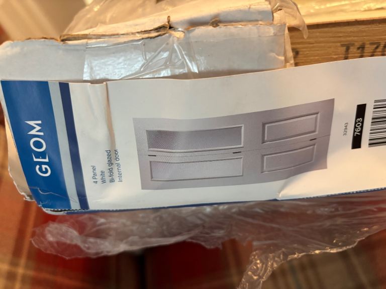 White bi-fold half glazed door. (1 Trim damaged ) 