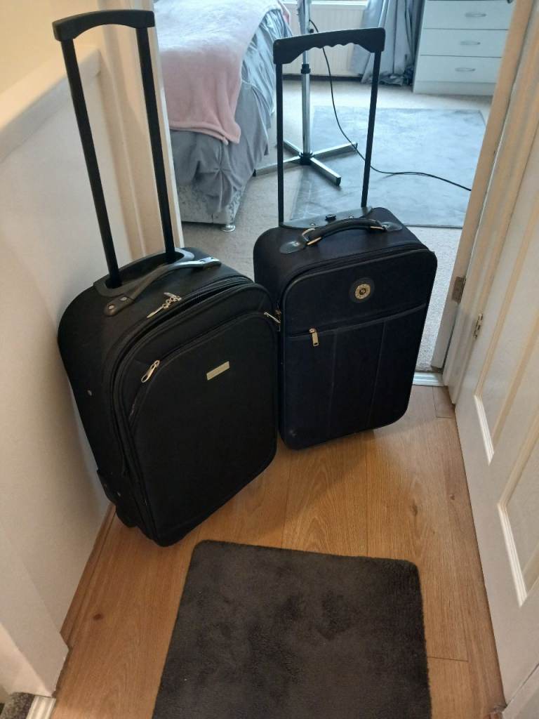 Two Black Suitcases with Wheels – Good Condition
