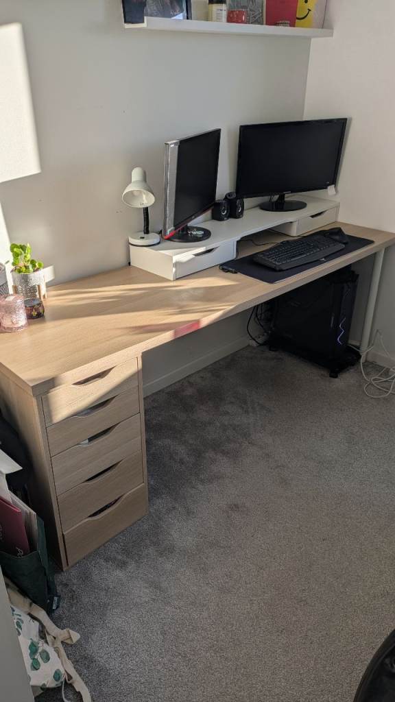 Desk with multiple drawers and monitor stand