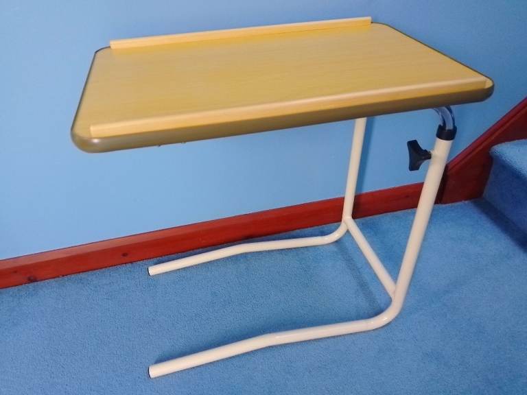 Over-bed table - adjustable height from approx 60cm to 100cm.