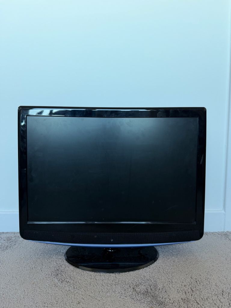 Black Flat Screen TV with Oval Stand