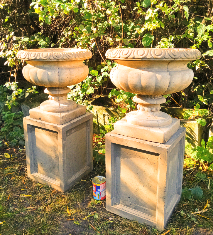 Match pair of stone urns on plinths very heavy