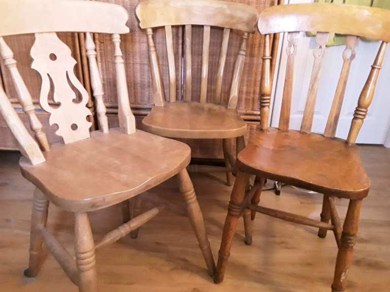 3 old farmhouse chairs, one slightly smaller than the others.