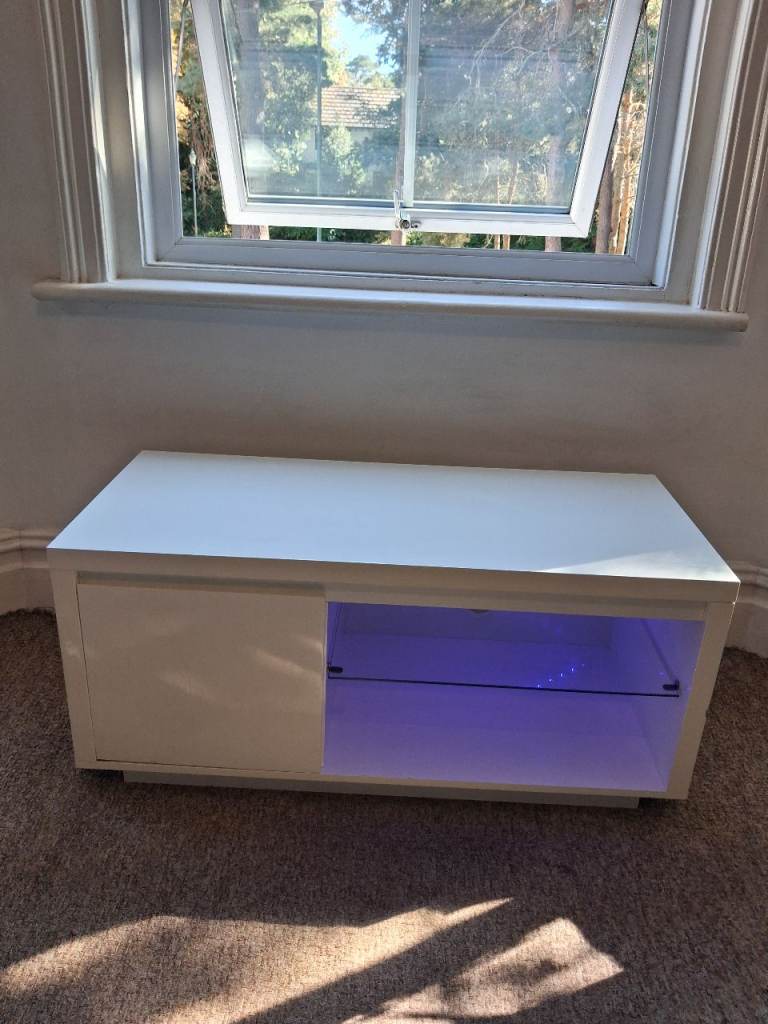 White TV unit with LED light and storage 