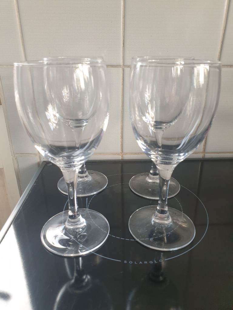 Four plain wine glasses 
