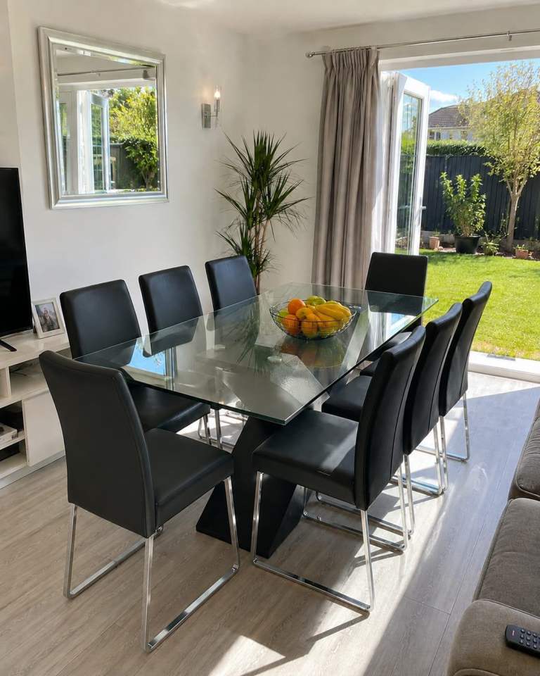 Glass Dining Table with 8 Black Chairs – Good Condition