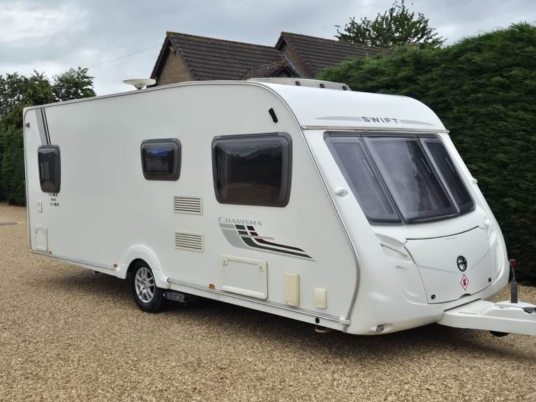 SWIFT CHARISMA 550 2010 4 BERTH FIXED BED CARAVAN + MOTOR MOVER + AWNING