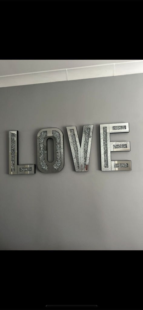 Large wall sign mirrored and with diamonds.