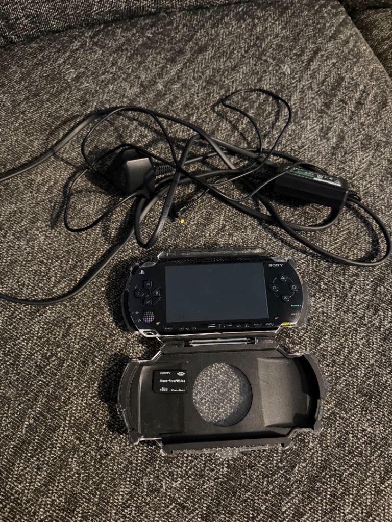 PSP 1000 with official charger 8gb SD and case.