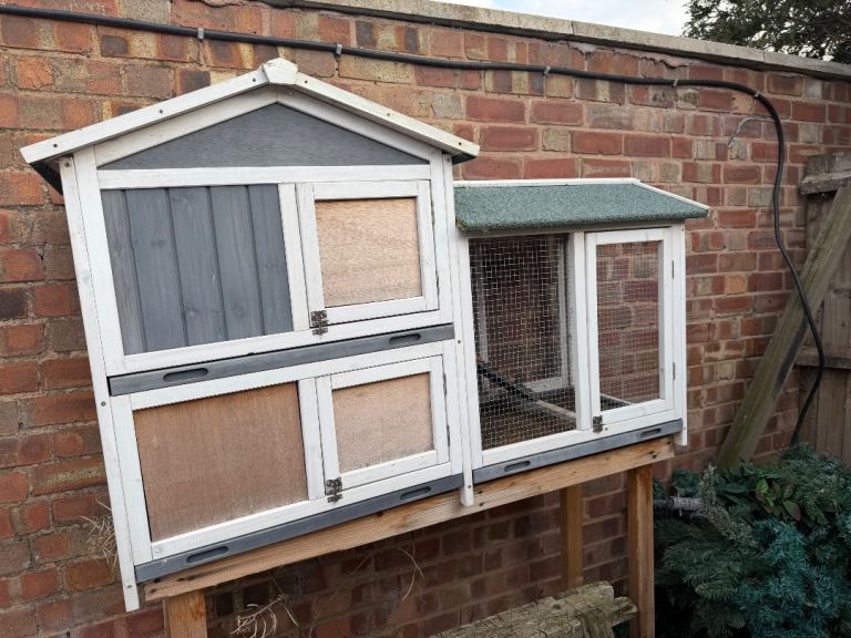 A animal hutch with mesh.