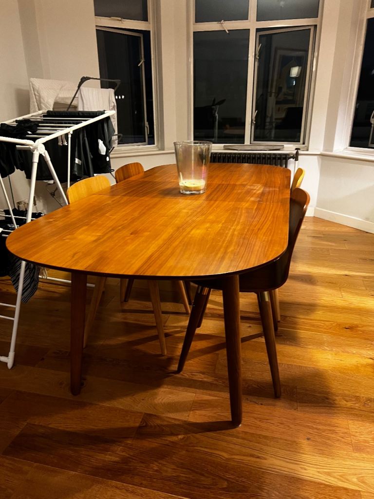 Oval wooden dining table with matching chairs