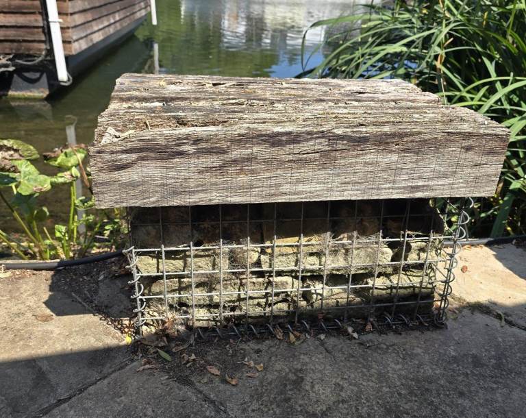 Metal gabion baskets selection filled with buff stones and sleeper top