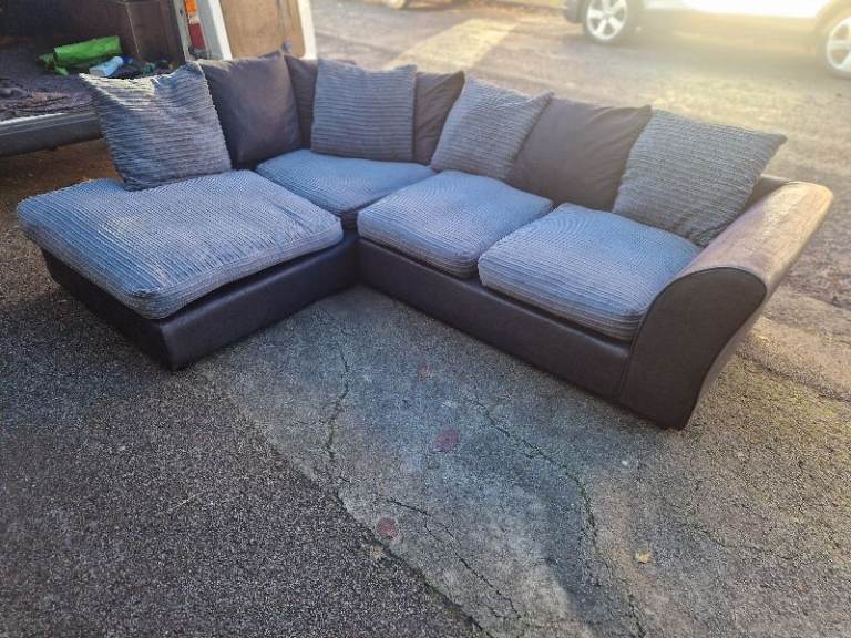 GREY CORNER SOFA IN GOOD CONDITION. NO COST HOME DELIVERY 