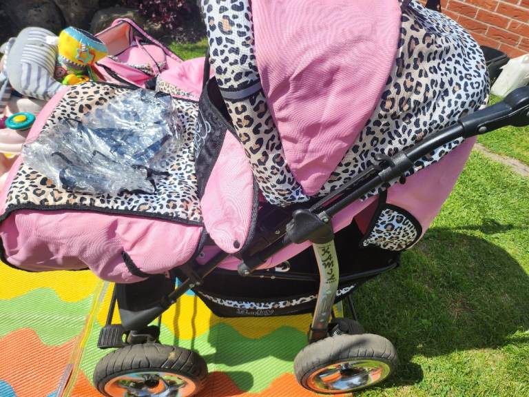 Pink and leopard print pram with accessories 