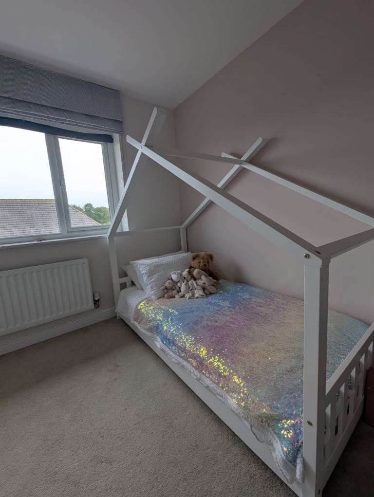 Single white wooden canopy bed