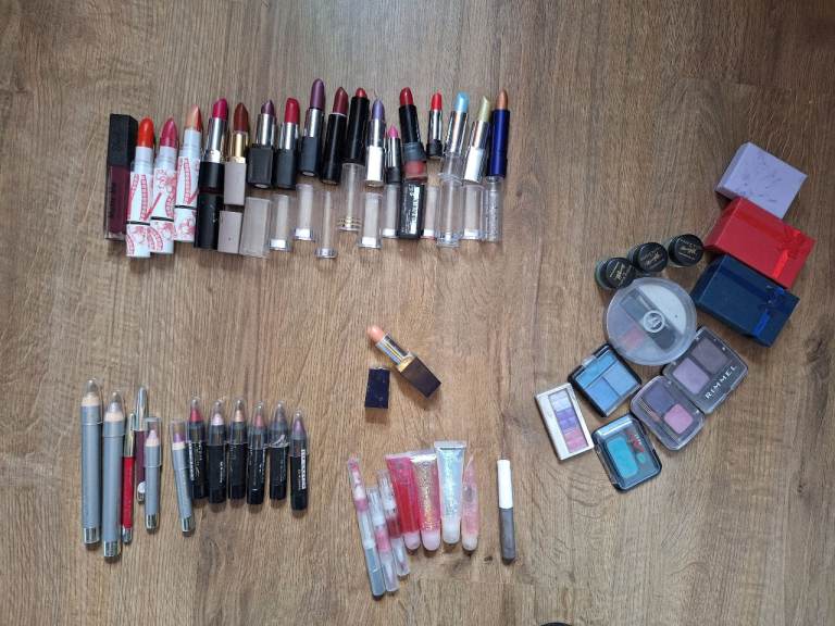 A bundle of ladies makeup lip stick some new, earing new and eyeshadow 