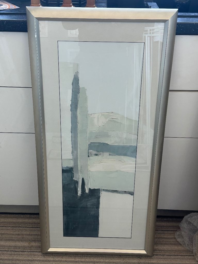 Framed abstract print in shades of grey with silver frame