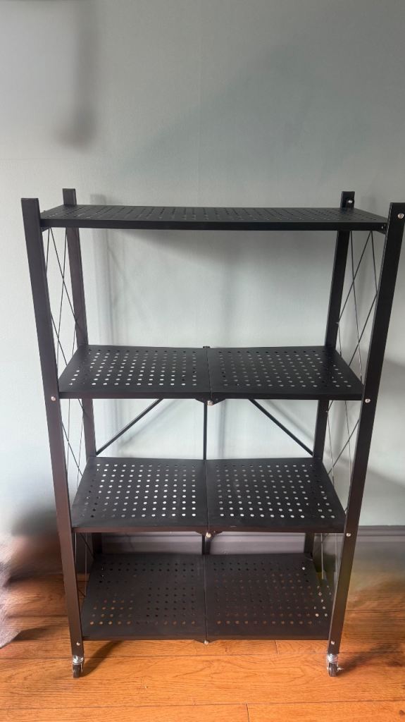 Brand New in the box Foldable storage shelf on wheels.    
