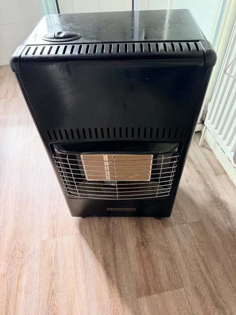 Black Gas Heater with Bottle Storage – Good Condition