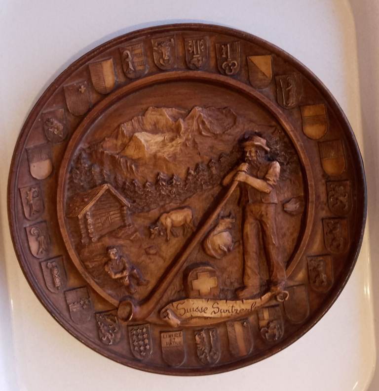 Swiss wooden wall plaque with 3D Alpine scene & surround of the shields of the cantons. 22cm dia.