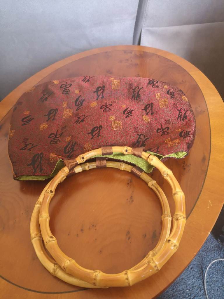 This is a Chinese silk embroidered bamboo effect handled bag