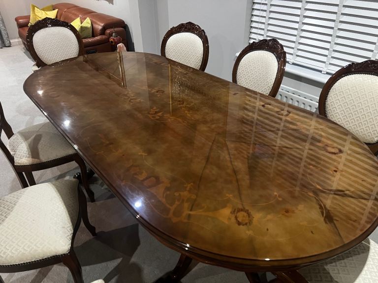 Elegant Glossy Dark Wood Dining Table with Intricate Inlay Design